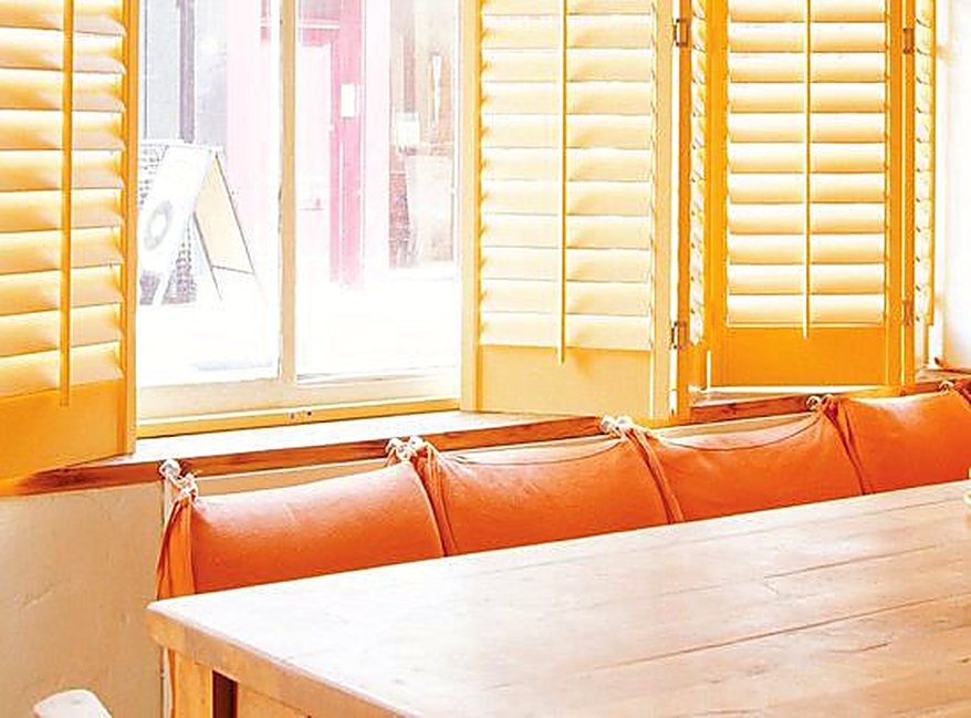 Golden painted café shutters glowing in sunlight